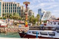 Entrance to marina, with promenades, modern hotel complexes, palms and boats, Eilat, Israel